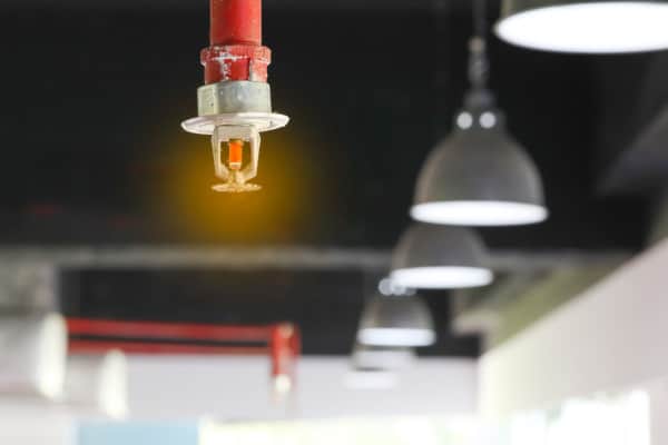 Fire sprinkler hanging from pipe