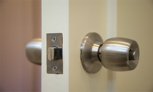 open door with door knob, latch, and strike plate