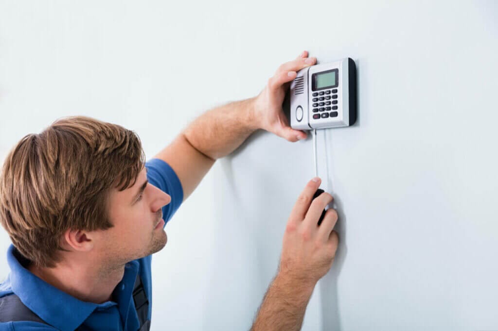 A technician installing a keyless door lock