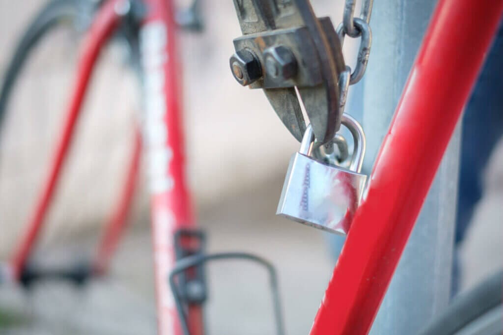 A padlock shackle getting cut by a bolt cutter