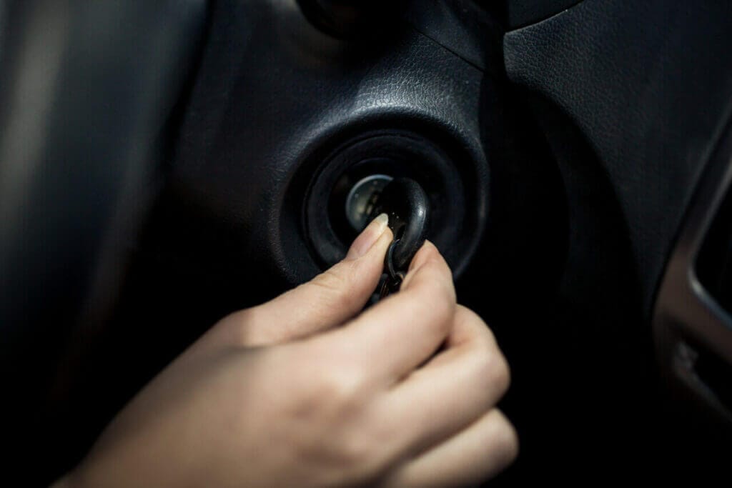 Close up of a hand inserting a key into ignition